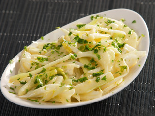 Daikon radish salad with parsley and vinegrette sauce shot over
