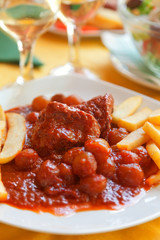 Beef Stifado. Crete style stew. French fries for side dish. Vert