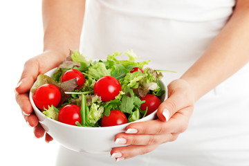 Salad bowl in woman hands isolated on white background