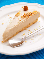 Vanilla cake with heavy cream. One piece on a white plate