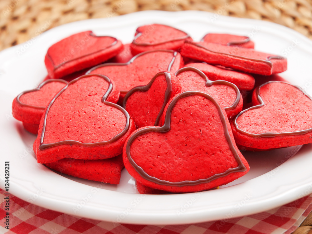 Wall mural homemade heart-shaped red cookies decorated with chocolate frost