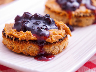 Toasts with peanut butter and cranberry jam. Horizontal shot