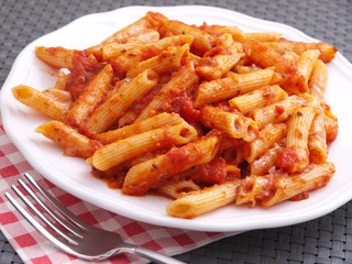 Penne pasta with tomatoes sauce. Horizontal shot