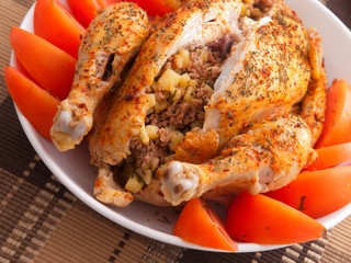Baked whole chicken stuffed with potatoes and minced meat