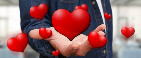 Young man holding hand drawn red heart