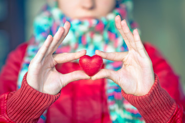 Heart shape love symbol in woman hands with face on background Valentines Day romantic greeting people relationship concept winter holiday