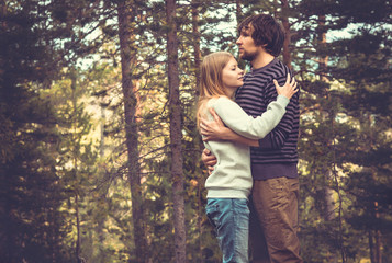 Young Couple Man and Woman Hugging in Love Romantic Outdoor with forest nature on background