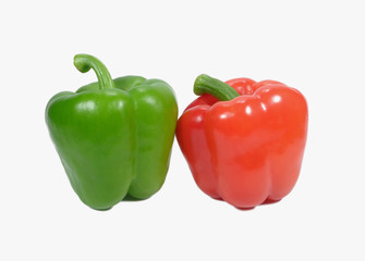 Close up of two ripe bell peppers with stem, one red and one green isolated on white background
