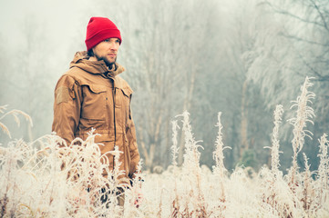 Young Man walking alone outdoor with foggy scandinavian forest nature on background Travel...