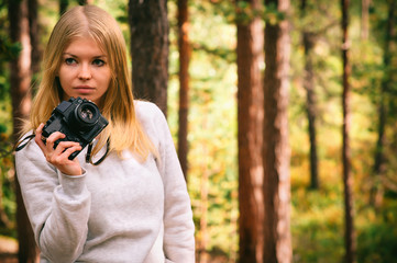 Young Woman with retro photo camera outdoor hipster Lifestyle forest nature on background