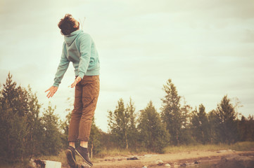 Young Man Flying levitation jumping outdoor relax Lifestyle happ - obrazy, fototapety, plakaty