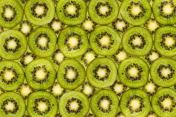 Background from slices of fresh kiwi fruit isolated on white
