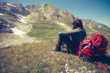Man Traveler with backpack relaxing outdoor Travel Lifestyle concept mountains on background Summer vacations