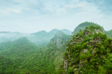 Blurry Background of Greenery of Mountain In Foggy Morning.