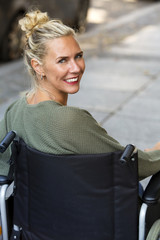 woman in wheelchair smiling at camera