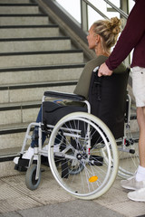 Fototapeta na wymiar woman in a wheelchair in front of stairs