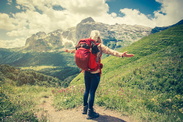 Traveler Woman with backpack hands raised mountaineering Travel Lifestyle concept Summer journey vacations outdoor mountains on background