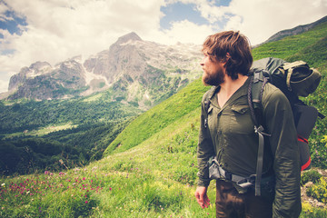 Fototapeta na wymiar Young Bearded Man Traveler with backpack mountaineering Travel Lifestyle concept mountains on background Summer adventure vacations outdoor