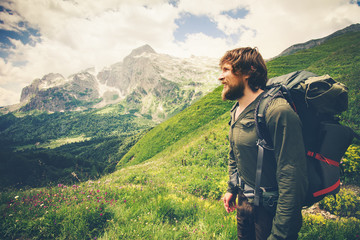 Fototapeta na wymiar Bearded Man with backpack hiking Travel Lifestyle concept mountains on background Summer journey adventure vacations outdoor