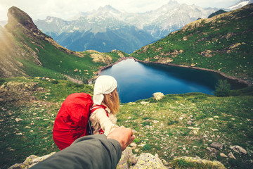Fototapeta na wymiar Woman Traveler with backpack holding Man hand following Travel hiking Lifestyle and relationship concept lake and mountains landscape on background