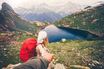 Fototapeta na wymiar Couple Woman with backpack holding Man hand following Travel hiking Lifestyle concept lake and mountains landscape on background
