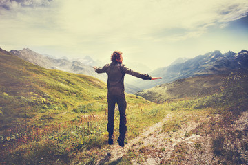 Traveler Man jumping with mountains landscape on background Lifestyle Travel happy emotions concept outdoor..