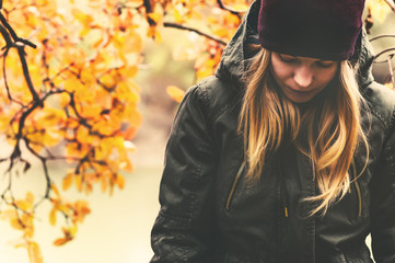 Sad Woman walking in park with autumn leaves on background outdoor Seasonal melancholy Lifestyle...