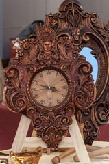 Floral woodwork analogue antique clock. Wooden frame