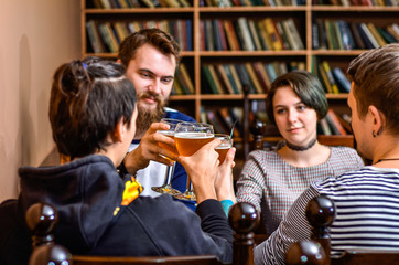 Friends clink glasses with beer