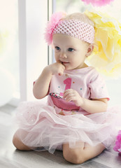 Portrait of one year-old baby girl indoors