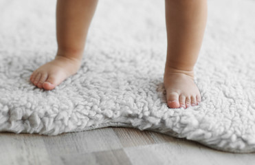 Obraz na płótnie Canvas Legs of little baby girl closeup