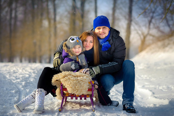 close-knit family in the snow wood