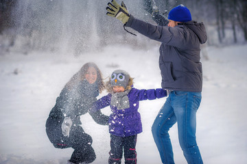 family plays snowballs