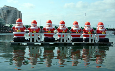 A bunch of inflated Santa Claus are decorating the Darling Harbour area in downtown Sydney during...