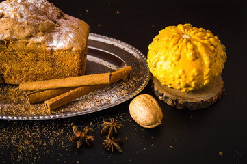 Cupcake with raisins on a tray. Pumpkin and cinnamon. On a wooden background.