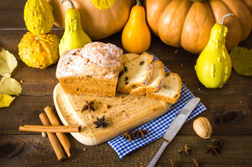 Cupcake with raisins on the board. Pumpkin and cinnamon. On a wooden background.