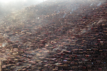Top view monastery at Larung gar (Buddhist Academy) in a warm and foggy morning time, Sichuan, China