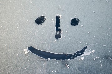 Emoticon/ Smiley face drawn on a frozen glass - 124442204