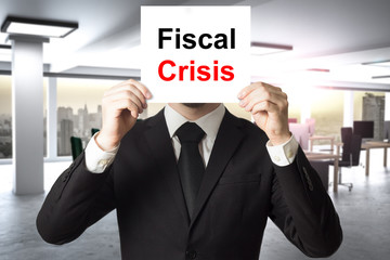 businessman hiding face behind sign fiscal crisis