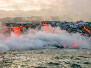 Schilderijen op glas Scenic view from boat of Kilauea Volcano in Hawaii Volcanoes National Park, while erupting lava into Pacific Ocean, Big Island, Hawaii, United States. © bennymarty