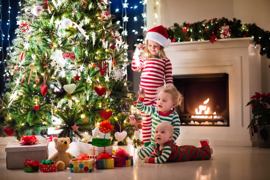 Kids In Pajamas Under Christmas Tree