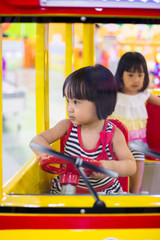 Fototapeta na wymiar Asian Chinese Little Sister Driving Toy Bus
