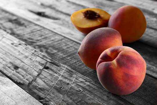 fresh sweet peaches on rustic wooden table. selective color