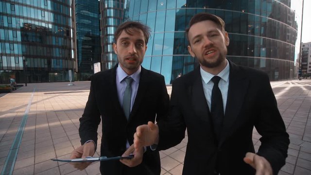 4k. Ultra HD. POV. Two attractive business competitors try to make You business offer. They interrupt themselfs. Be the main and first in all concept. Businessmen. Sunrise. Glass business district
