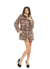 Portrait in full growth on a beautiful woman short mink coat