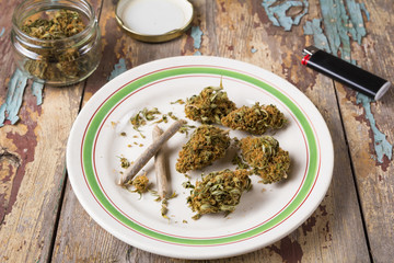 Marijuana buds and joints in the white plate