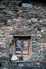 Broken window on stone wall