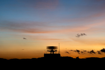 Silhouette of a rotating antenna secondary surveillance radar wi