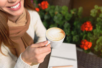 Cheerful woman resting in cafe