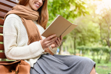 Pretty female student studying in nature